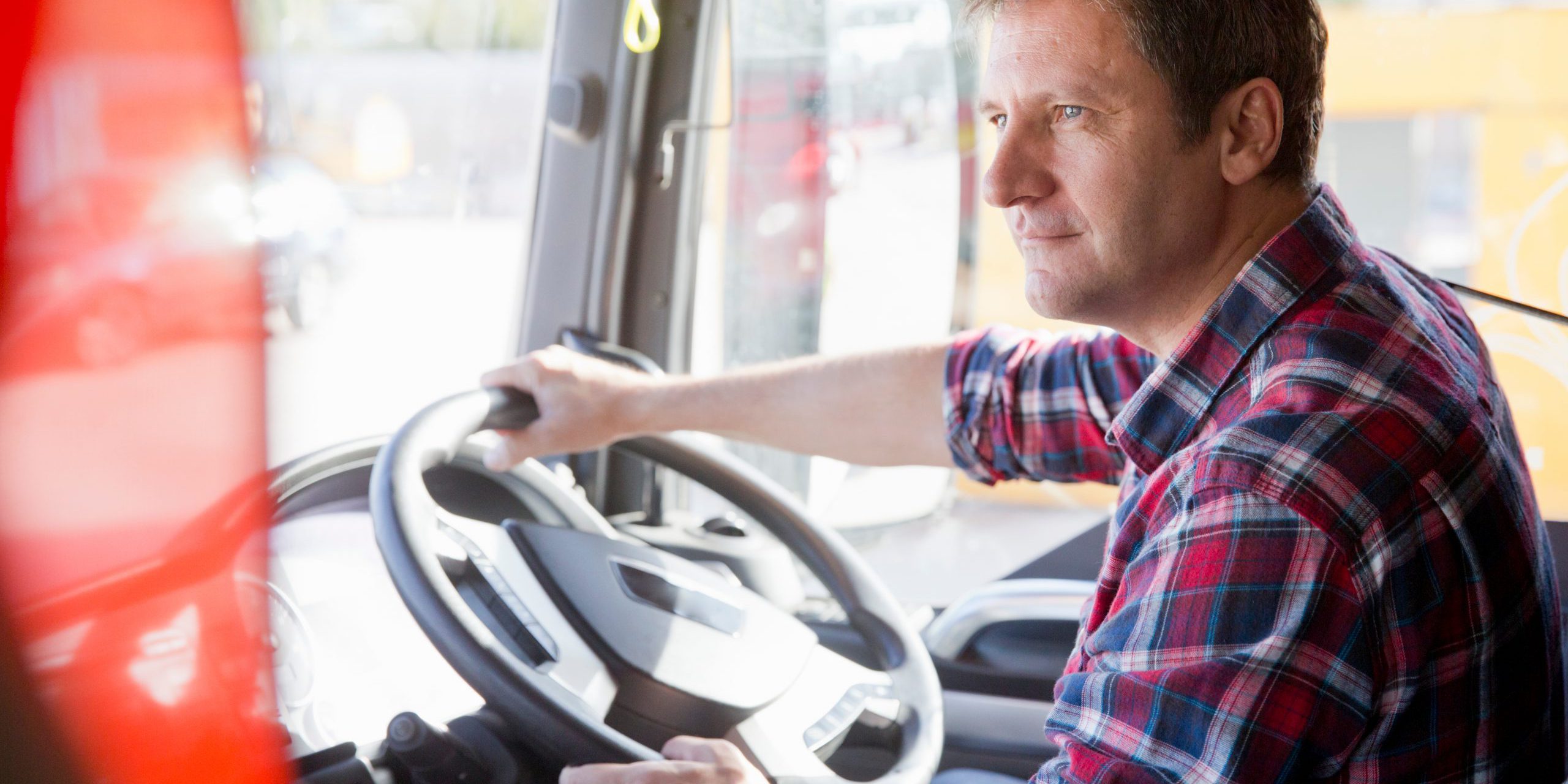 Truck,Driver,Driving,In,Cab,Of,Semi-truck